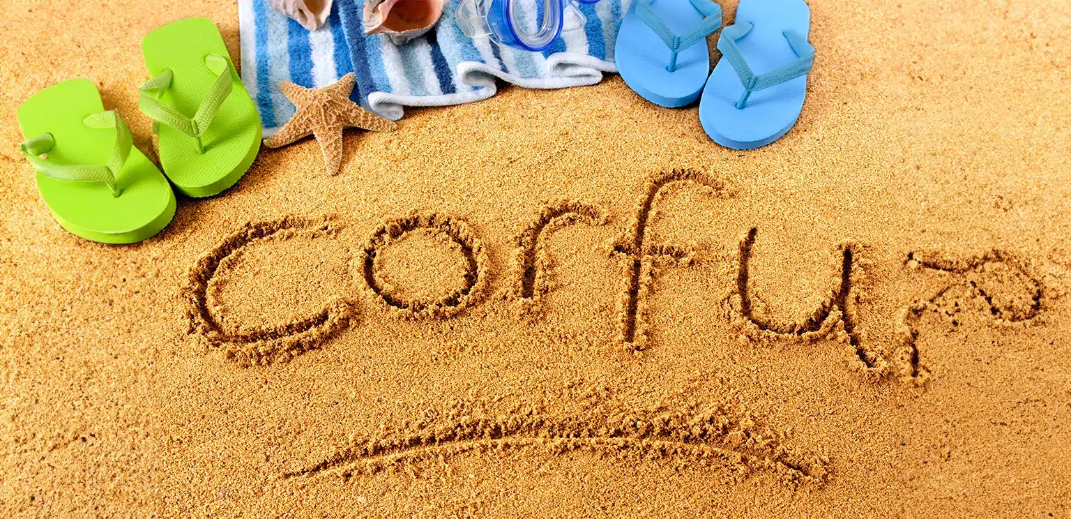 corfu written on a golden sand